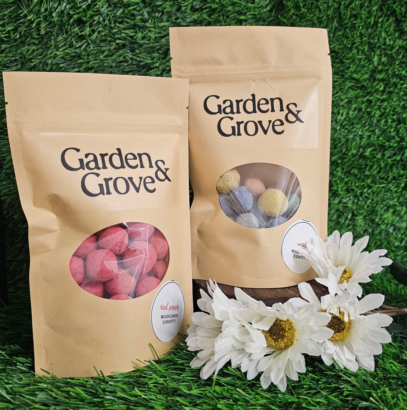 Two Garden & Grove bags with window揭开显示内容, accompanied by white flowers on grass.