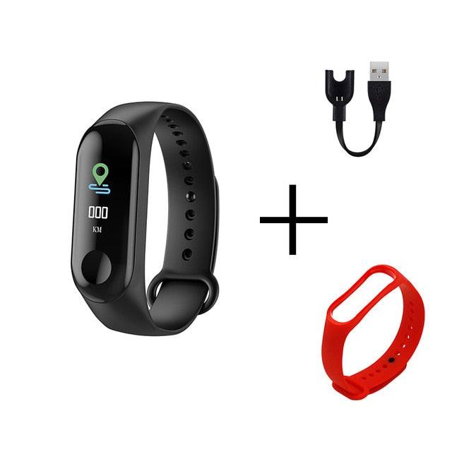 Black fitness tracker with a red strap, USB cable, and additional strap on a white background