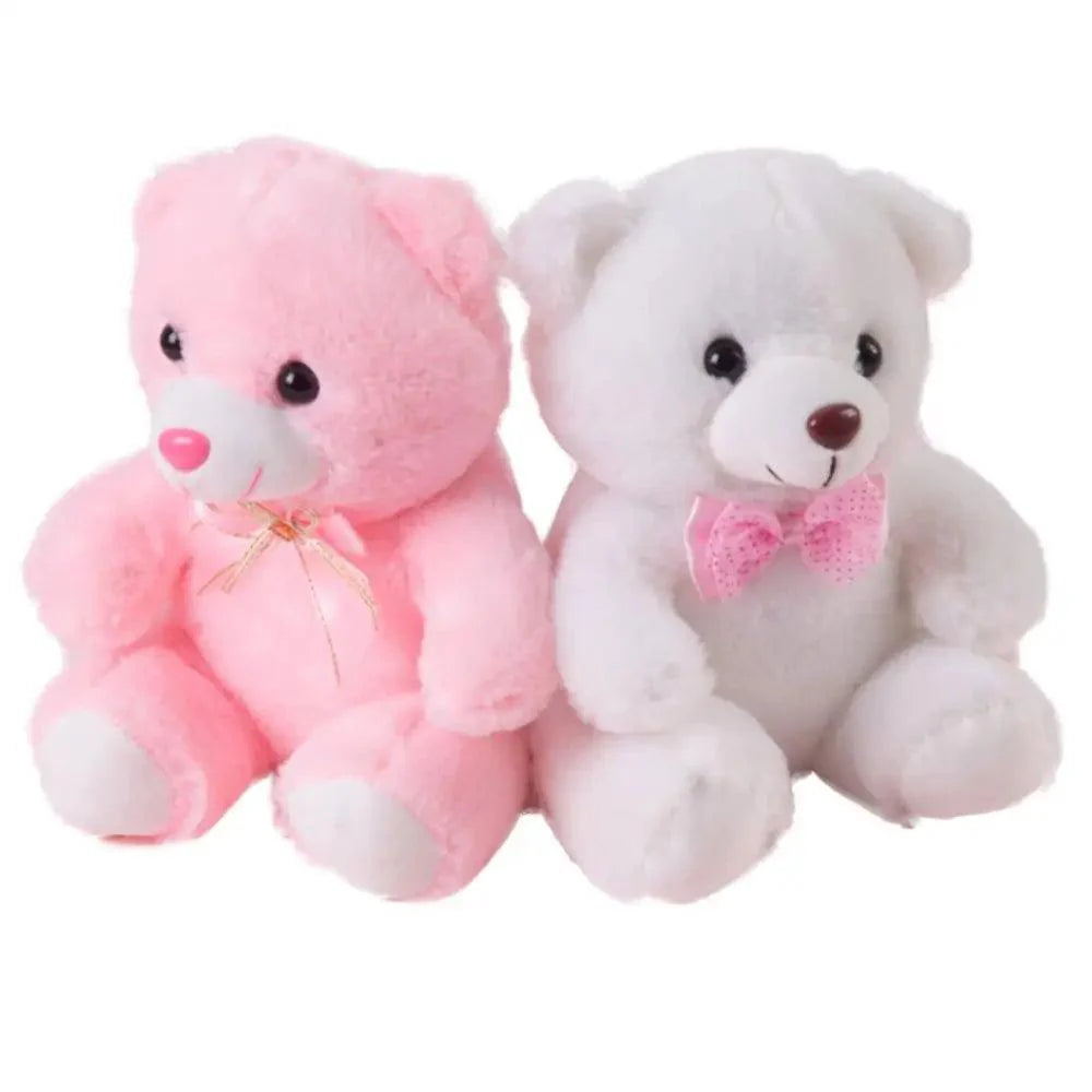 Two teddy bears, one pink and one white, sitting side by side on a white background.