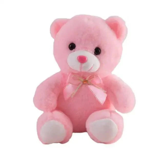 Pink teddy bear with a bow on a white background