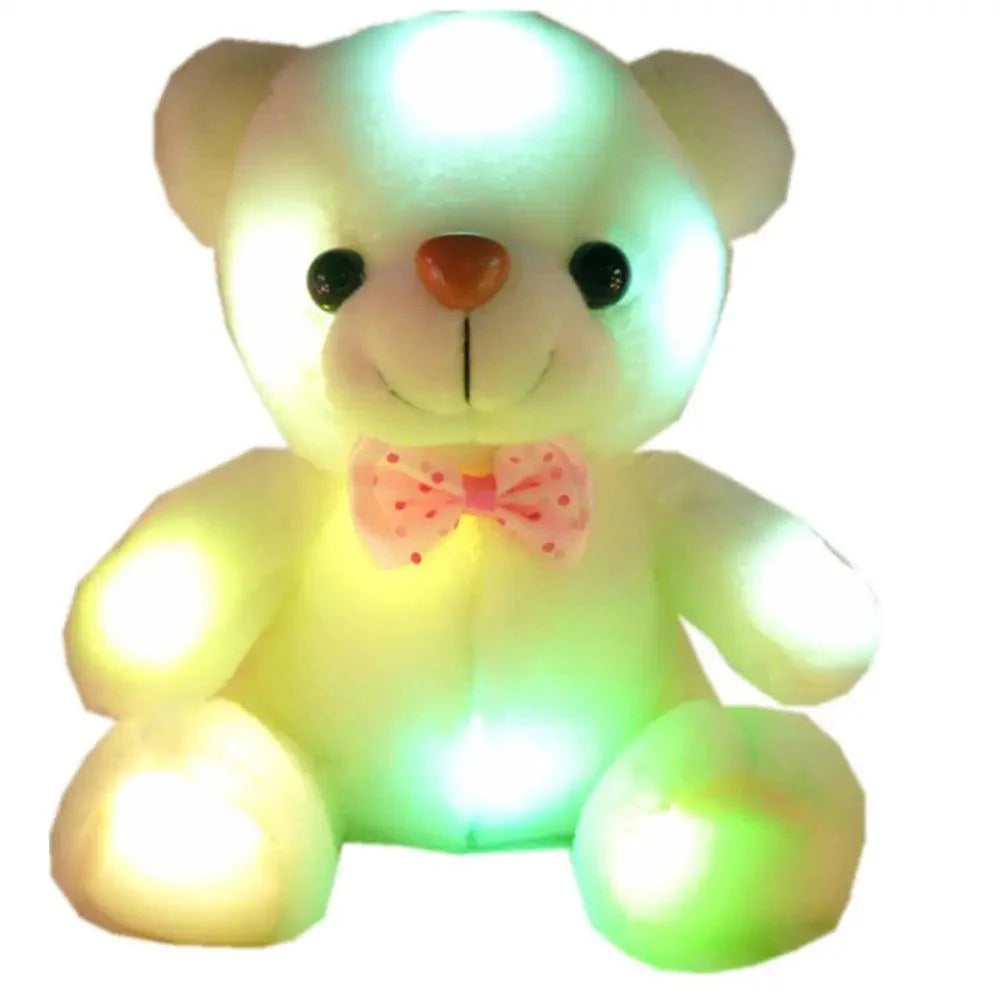 Glowing teddy bear with a pink bow on a white background