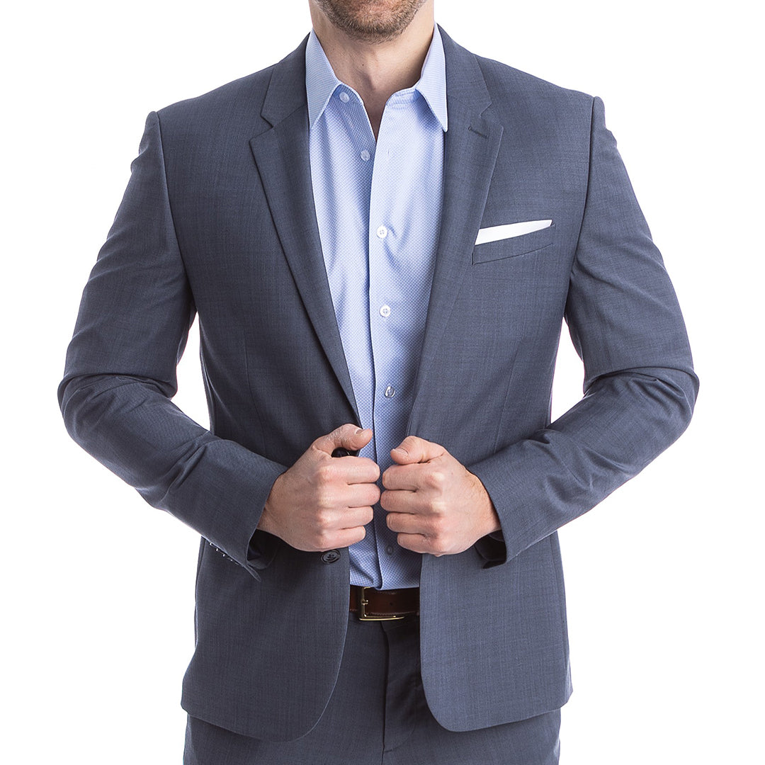 Man wearing a gray suit jacket over a light blue shirt on a white background