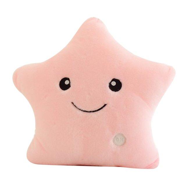 Pink star-shaped pillow with a smiley face on a white background