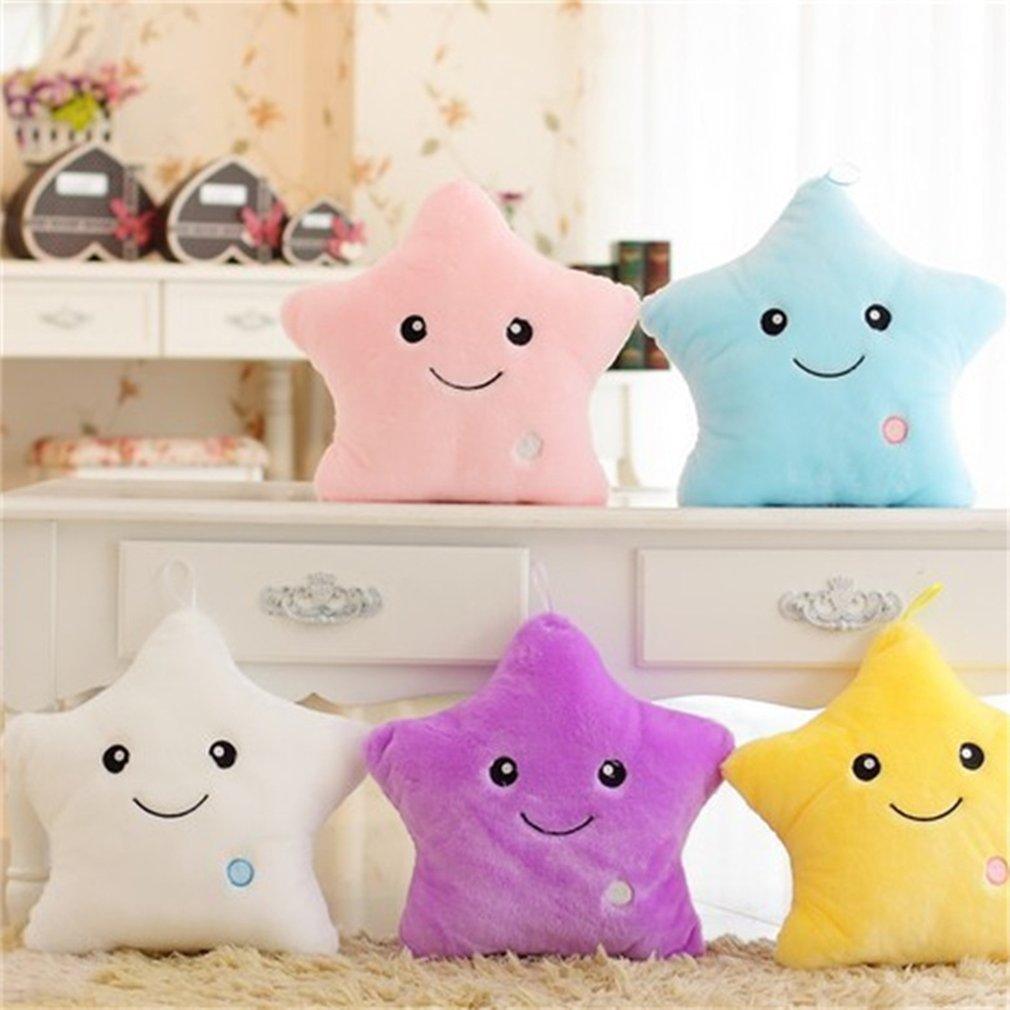 Five star-shaped plush toys in pink, blue, white, purple, and yellow on a decorative shelf.