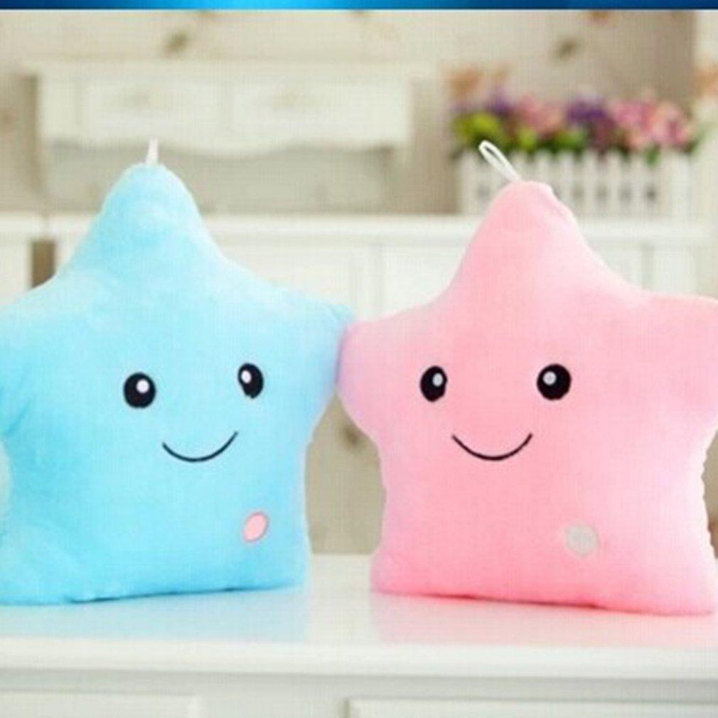 Two star-shaped plush toys, one blue and one pink, on a white surface with a blurred background.