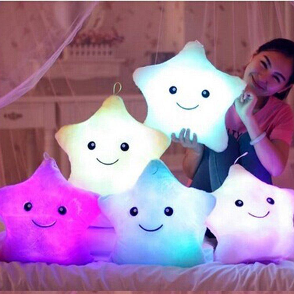 Colorful star-shaped plush toys with LED lights on a bed.