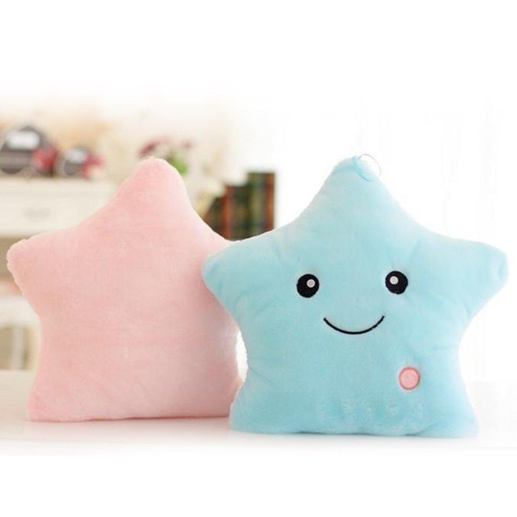 Two star-shaped cushions, one pink and one blue with a smiley face, on a blurred background.