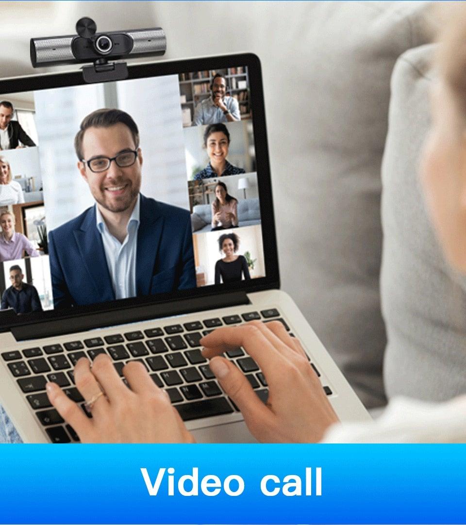 Person using a laptop for a video call with multiple participants.