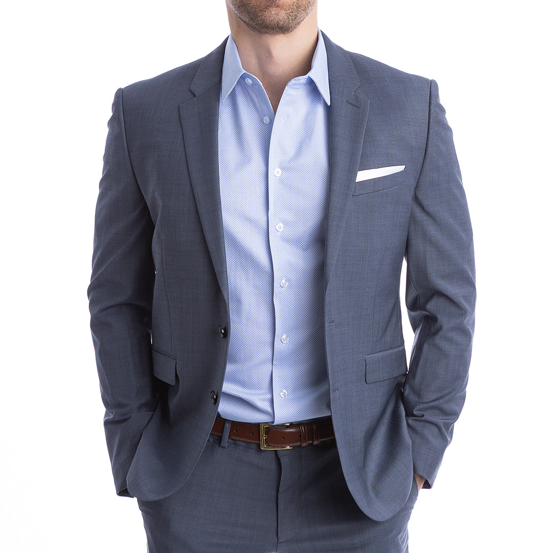 Man wearing a gray suit jacket over a light blue shirt on a white background