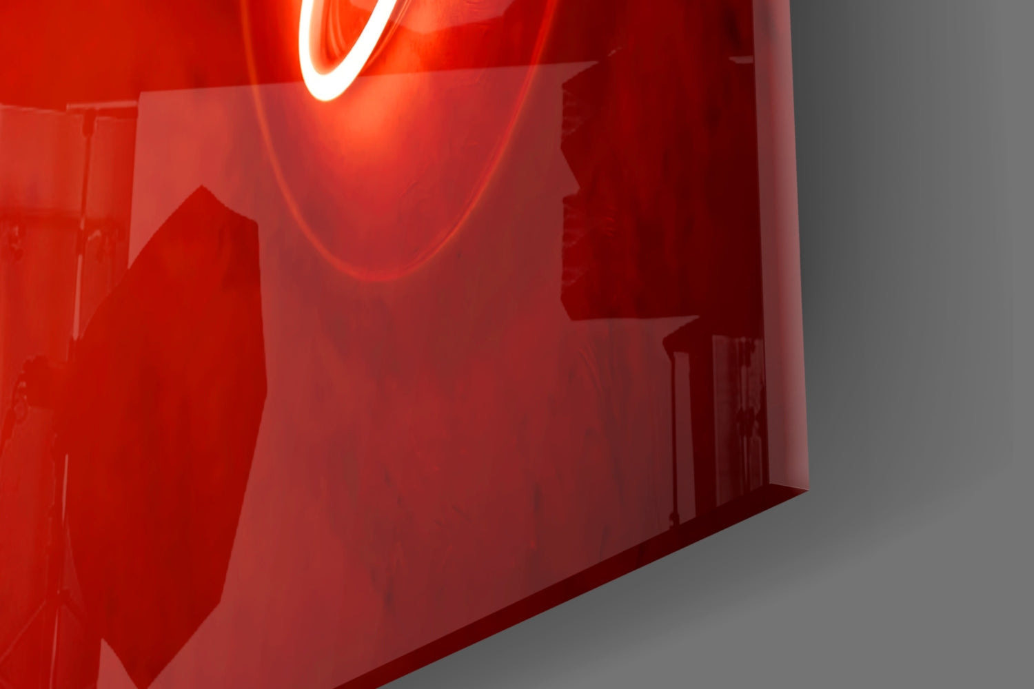 Close-up of a red electronic device with a glowing component on a gray background